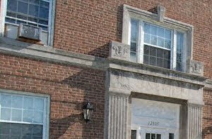 the front of a brick building with a white door