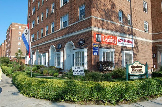 a large brick building with a sign in front of it