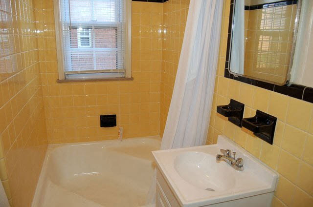a bathroom with a sink and a tub and a window