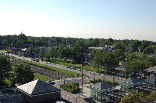an aerial view of a city with a train track