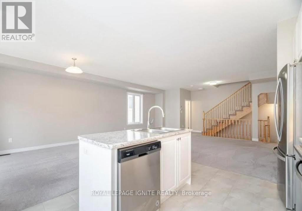 A kitchen with white appliances and a marble countertop.