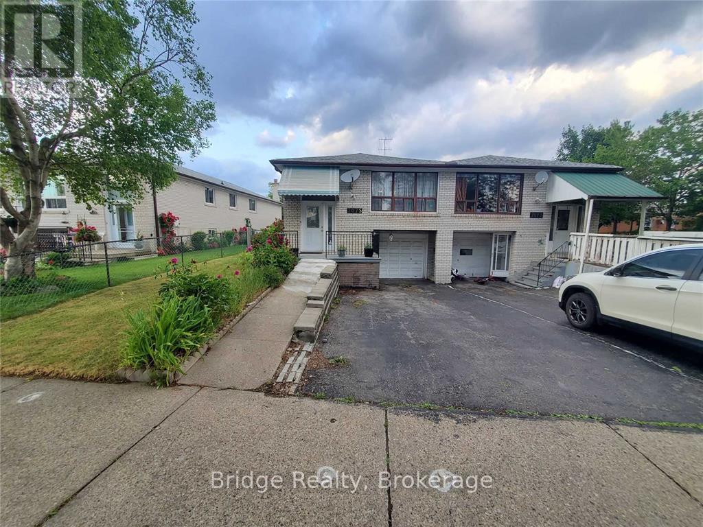 A white car is parked in front of a two-story house with a garage.