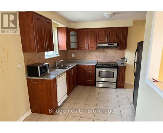A kitchen with wooden cabinets and stainless steel appliances.