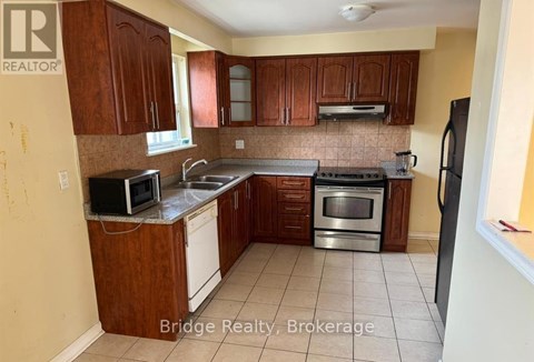 A kitchen with wooden cabinets and stainless steel appliances.