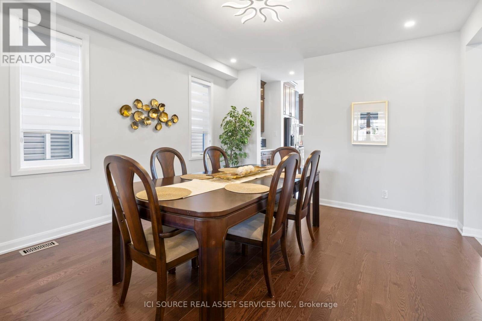A dining room with a table set for six.