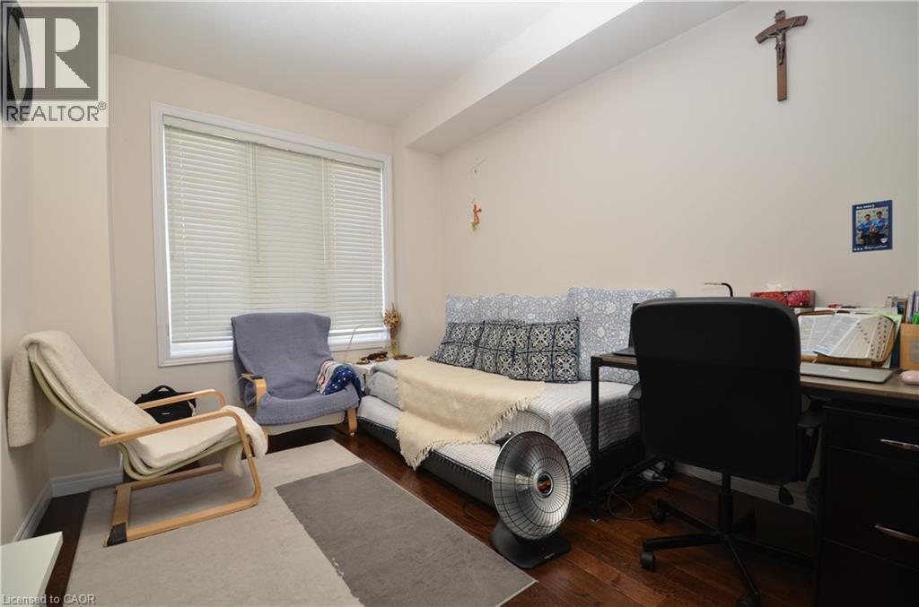 A bedroom with a bed, chair, and desk.