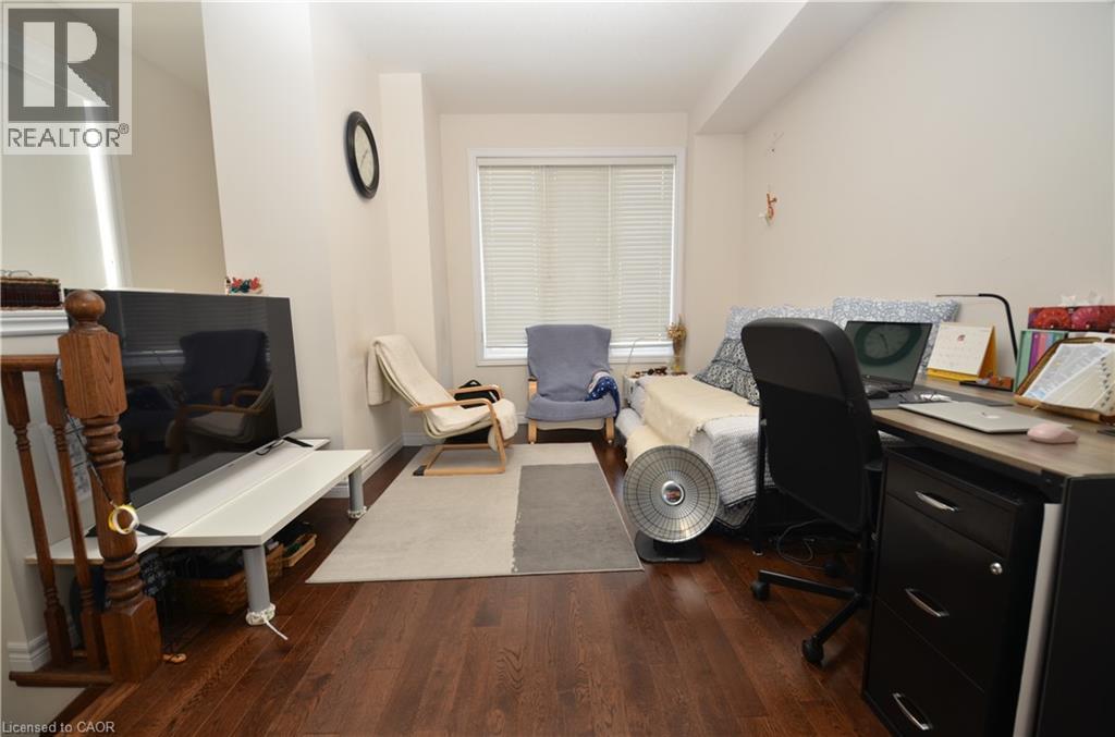 A living room with a couch, chair, and television.