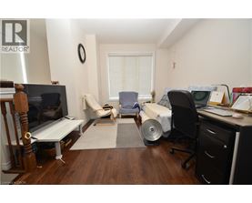 A living room with a couch, chair, and television.