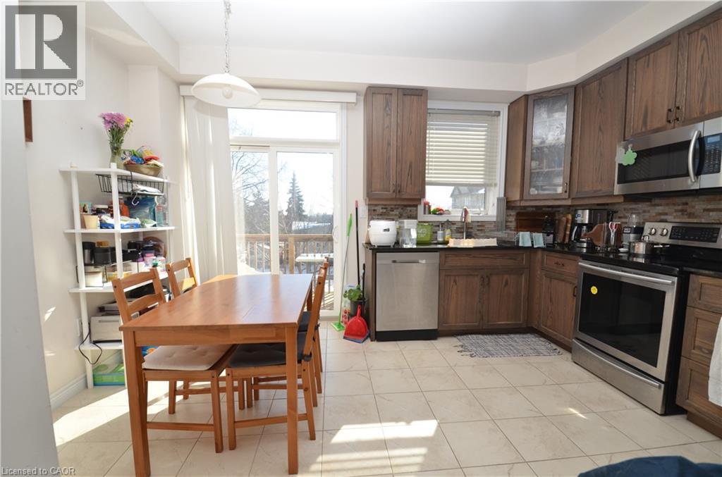 A kitchen with a table and chairs in the middle of the room.