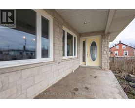 A real estate company's sign is on the window of a house.