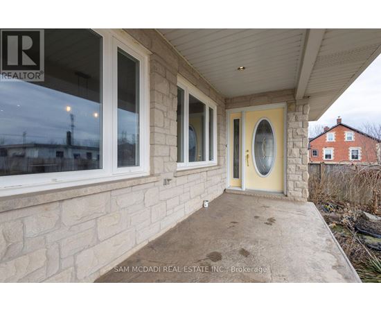 A real estate company's sign is on the window of a house.