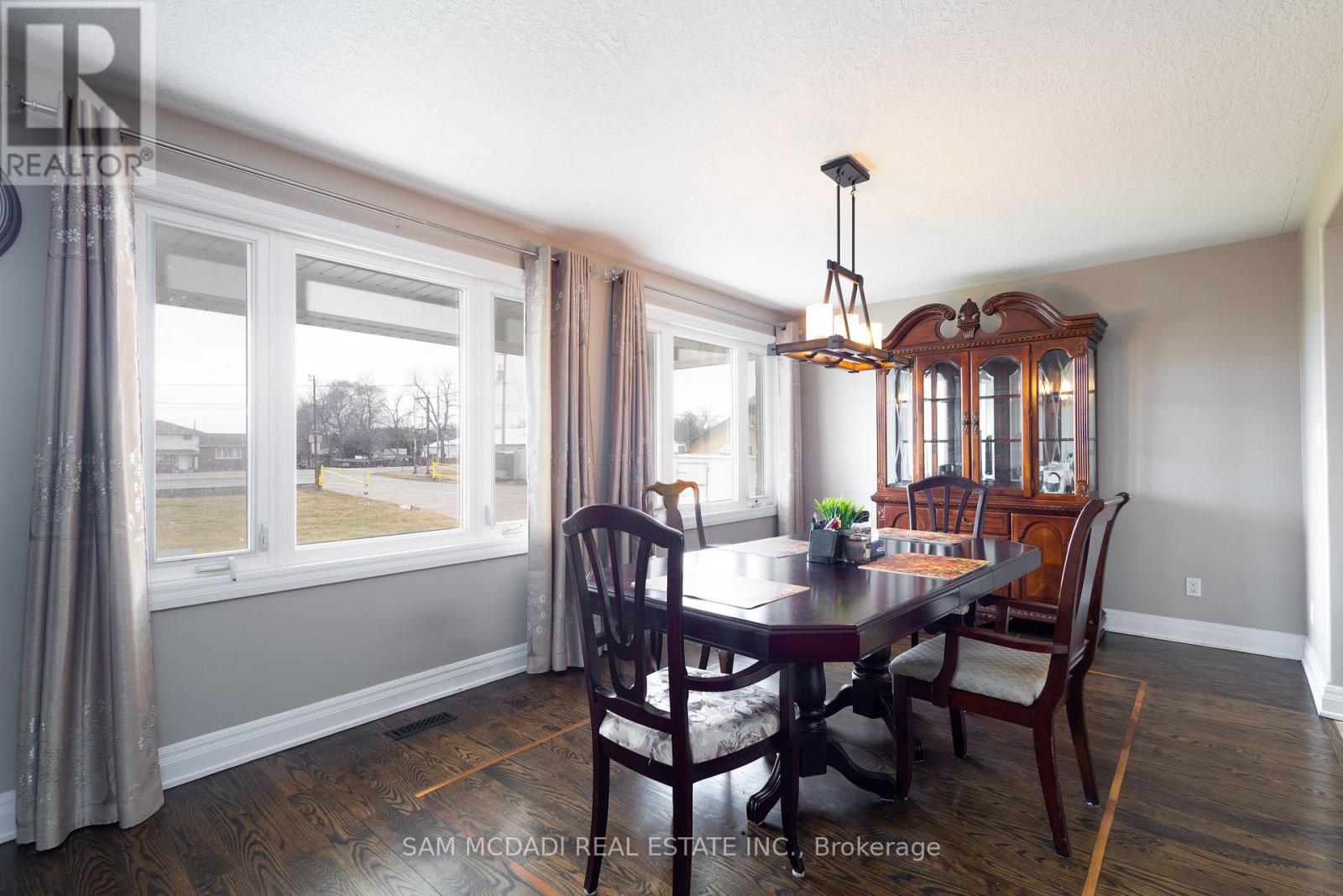 A dining room with a table set for four.