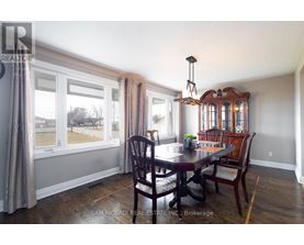 A dining room with a table set for four.