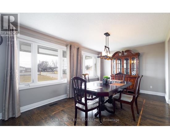 A dining room with a table set for four.