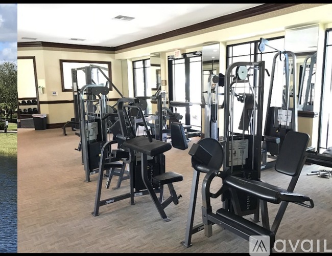 A gym with a variety of equipment including a leg press machine and a chest press machine.