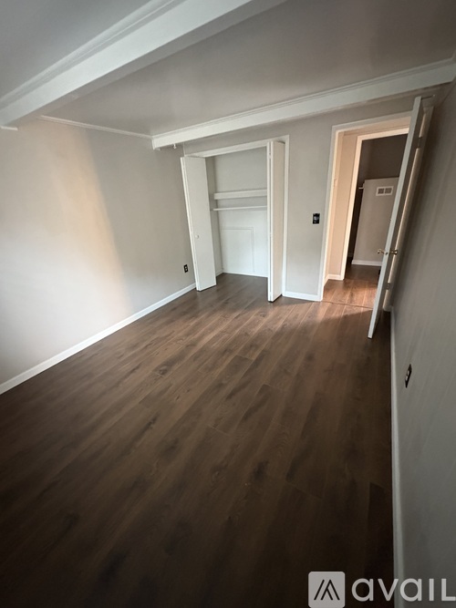 A room with wooden floors and white walls.