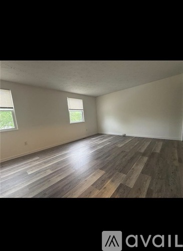 A room with a carpeted floor and a doorway leading to another room.