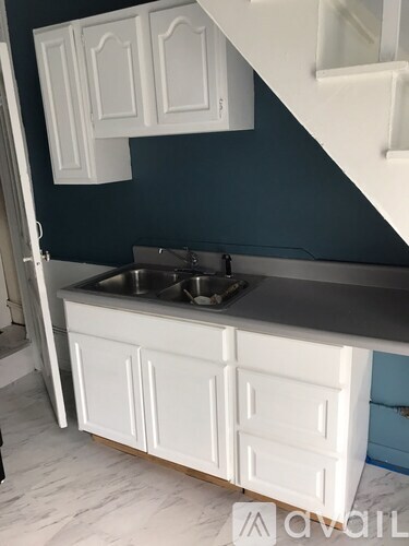 A kitchen with a sink and cabinets.