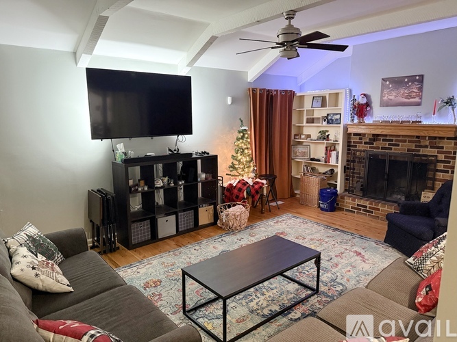 A living room with a fireplace, a television, and a coffee table.