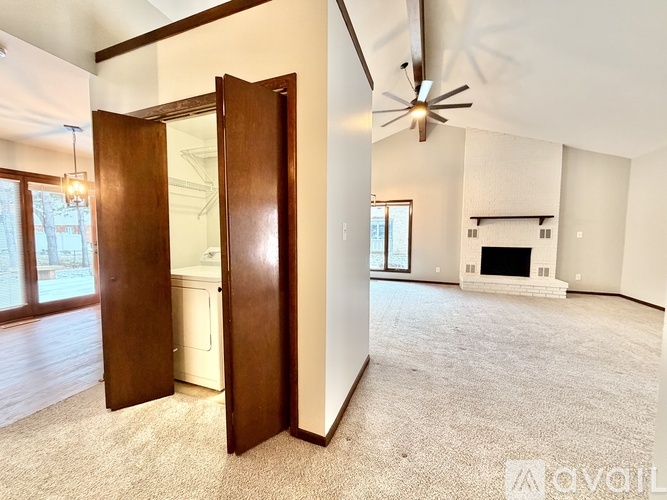 A room with a fireplace and a ceiling fan.