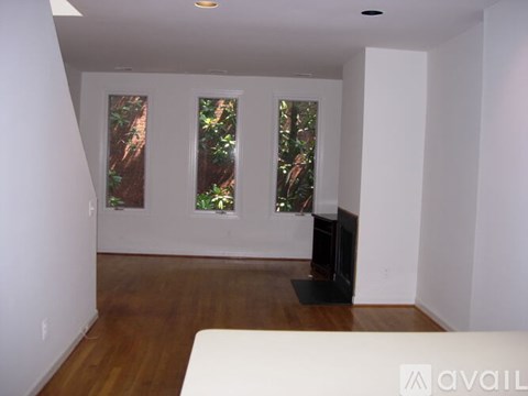 A living room with a white couch and a television.
