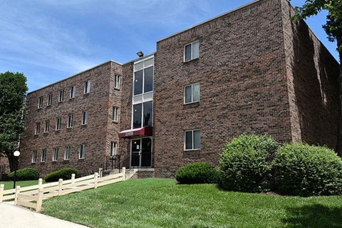a brick building with a green lawn in front of it