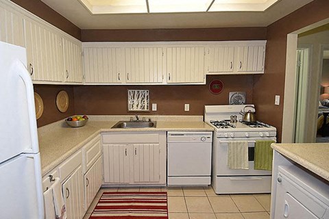 a kitchen with white appliances and white cabinets