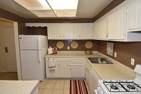 a kitchen with a stove and a refrigerator