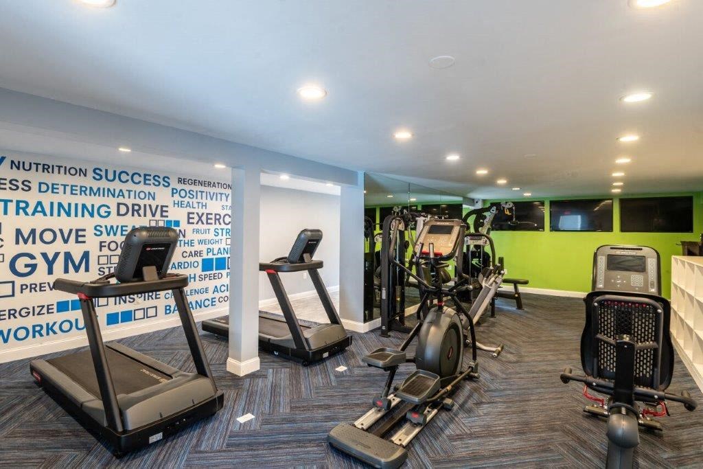 a gym with treadmills and other exercise equipment