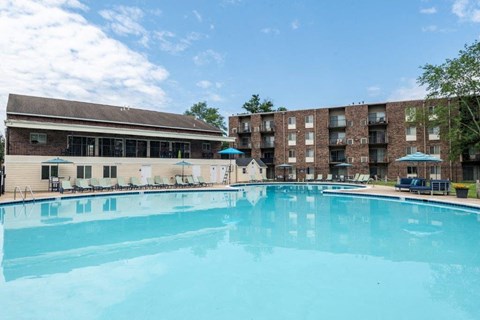 a large swimming pool in front of a hotel