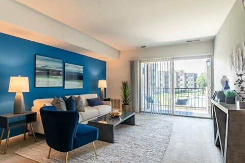 a living room with a blue accent wall and a couch