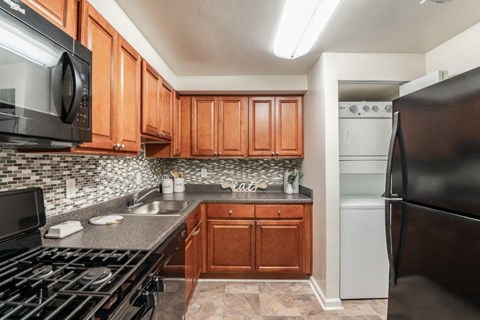 a kitchen with stainless steel appliances and wooden cabinets