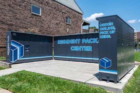 a black container with a sign on it in front of a building