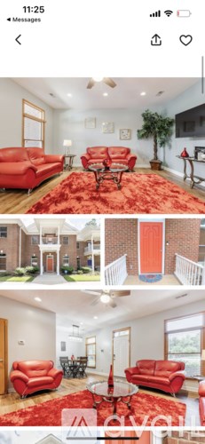 A living room with red sofas and a red rug.
