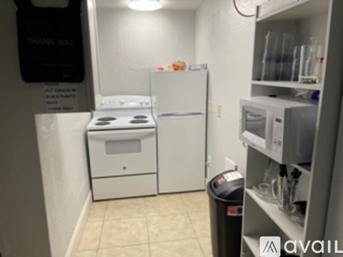 A kitchen with a white fridge, white stove and white oven.