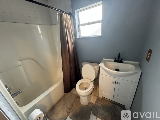 A small white kitchen with a sink and a cabinet.