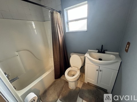A small white kitchen with a sink and a cabinet.