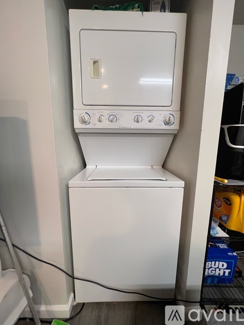 A white oven with a white door and four knobs on the front.
