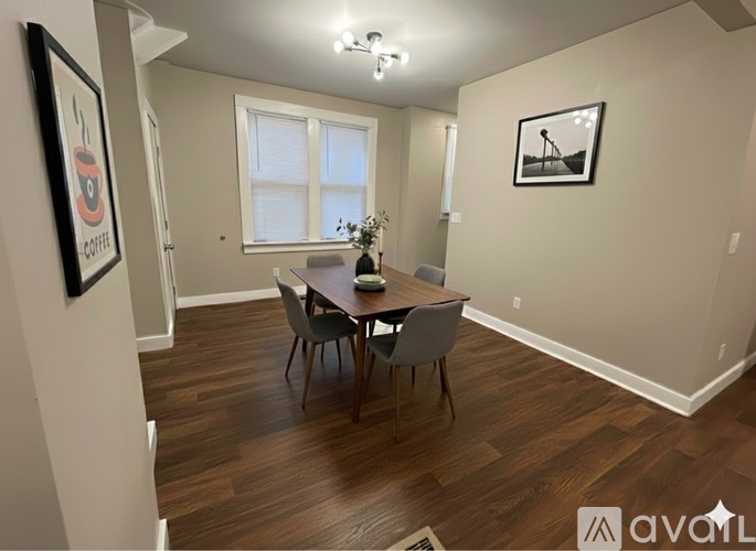 A dining room with a wooden table and chairs.