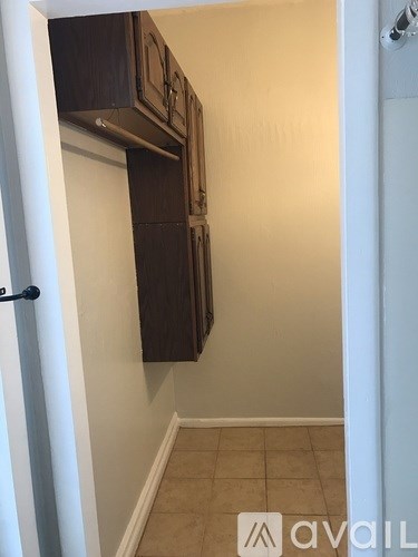 A kitchen with brown cabinets and a white door.