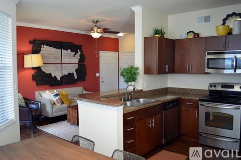 A kitchen with a white island and wooden cabinets.