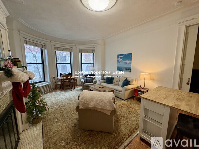 A living room with a Christmas stocking hanging on the fireplace.