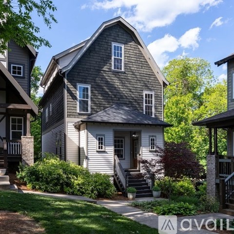 A house with a grey exterior and a porch.