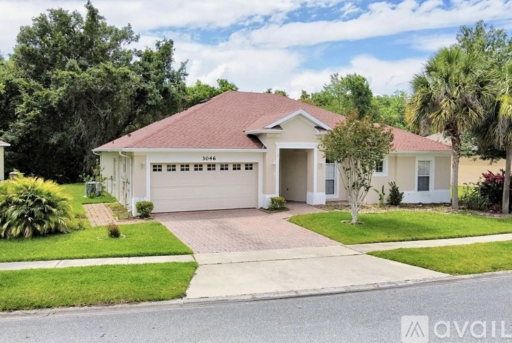 A house with a red roof and white walls is for sale.