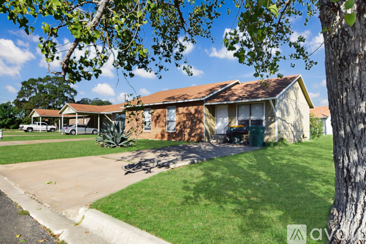 A house with a white door and a brown roof is for sale.