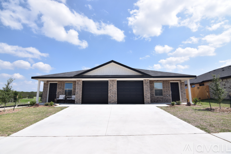 A house with a black garage door is for sale.