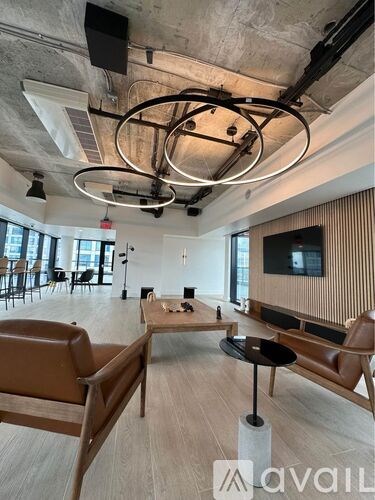 A modern living room with a large brown leather sofa and a wooden coffee table.