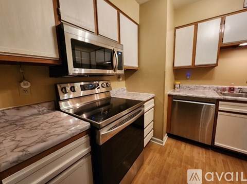 A kitchen with a stove top oven and microwave above it.