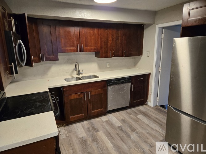 A kitchen with wooden cabinets and a white countertop.