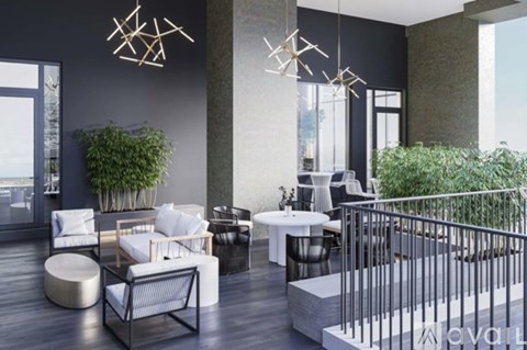 A modern living room with a glass table and white chairs.